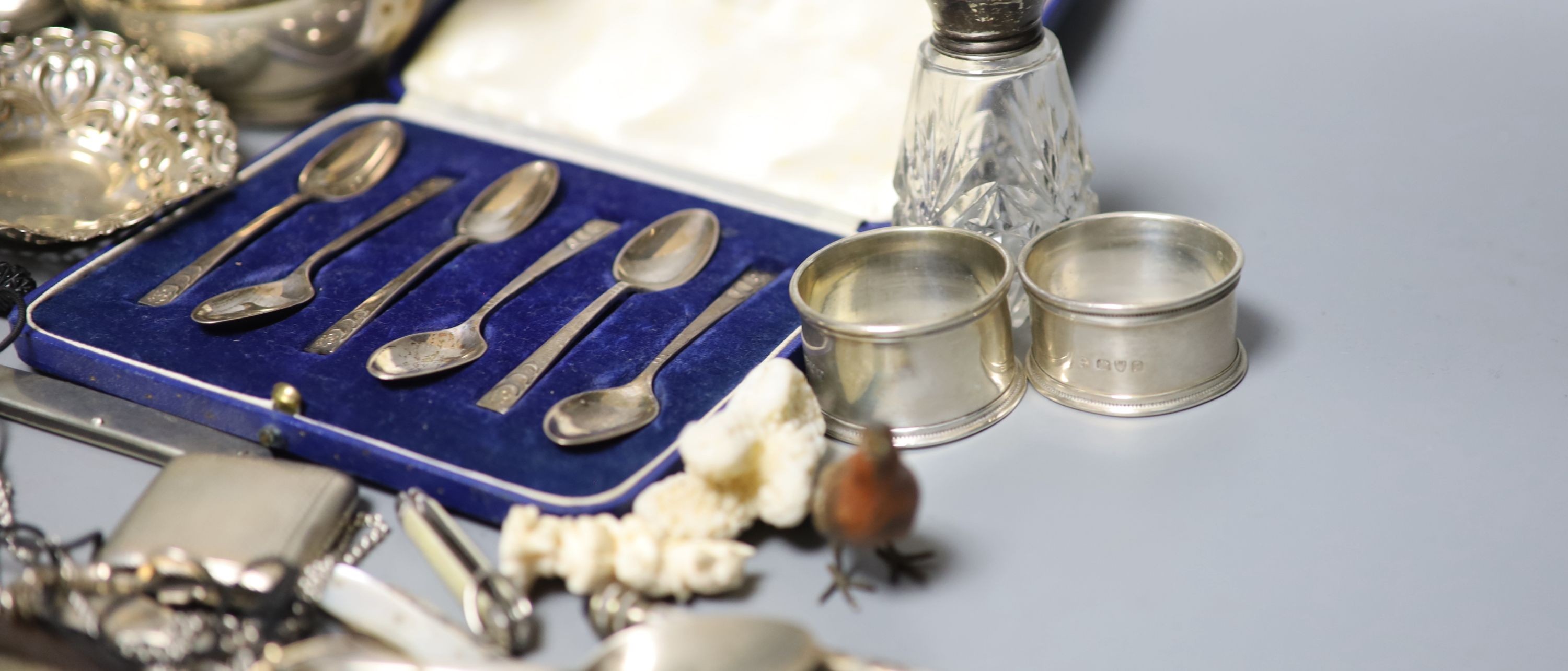 Mixed small silver and other collectable including a cased set of silver silver coffee spoons, a George III silver cream jug, bonbon dishes, cigarette cases, vesta case, flatware, scent bottles, a cold painted bronze bir